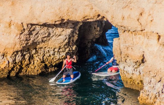 LAGOS, PORTUGAL - OCTOBER 7, 2017: Stand-up paddleboarding at the cliffs near Lagos, Portugal.